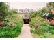 Lush landscaping frames this grand brick apartment building, offering a serene and inviting entrance at 1165 N Pennsylvania St # 3B, Denver, CO 80203