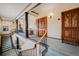 Elegant hallway features hardwood doors, columns, ornate railings and staircase access to multi-level apartments at 1165 N Pennsylvania St # 3B, Denver, CO 80203