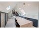 Modern kitchen features a large island with quartz countertops, and skylights with an open layout to the loft area at 1165 N Pennsylvania St # 3B, Denver, CO 80203