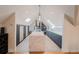 Modern kitchen with a large island with a quartz countertop, skylights, and lots of cabinets for storage at 1165 N Pennsylvania St # 3B, Denver, CO 80203