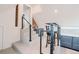 Upstairs landing with stairs, wet bar, stainless steel appliances, and access to additional living spaces at 1165 N Pennsylvania St # 3B, Denver, CO 80203