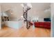Spacious open-concept living room with a unique spiral staircase and hardwood floors at 1165 N Pennsylvania St # 3B, Denver, CO 80203