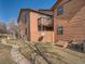 Backyard featuring a grassy area, a well-maintained rock feature, and orange siding at 9477 W 89Th Cir, Broomfield, CO 80021