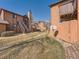 Backyard featuring a grassy area and a well-maintained stone chimney at 9477 W 89Th Cir, Broomfield, CO 80021
