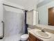 Bathroom with marble style tile shower with grab bar and a white vanity at 9477 W 89Th Cir, Broomfield, CO 80021