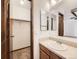 Bathroom featuring a single sink vanity, large mirror and closet space at 9477 W 89Th Cir, Broomfield, CO 80021