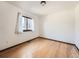 Bedroom featuring hardwood floors and a large window at 9477 W 89Th Cir, Broomfield, CO 80021