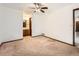Bedroom featuring neutral carpet and a view of an attached bathroom at 9477 W 89Th Cir, Broomfield, CO 80021