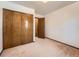 Bedroom with a closet with wood doors, offering ample storage space at 9477 W 89Th Cir, Broomfield, CO 80021