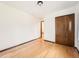 Bedroom featuring hardwood floors and a closet with doors at 9477 W 89Th Cir, Broomfield, CO 80021