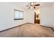 Spacious bedroom with a ceiling fan, window and entry to attached bathroom at 9477 W 89Th Cir, Broomfield, CO 80021