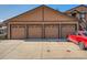 Multiple brown garage doors are seen in the exterior image, each marked with a unit number at 9477 W 89Th Cir, Broomfield, CO 80021