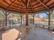 Interior view of a wood gazebo with seating and string lights for outdoor relaxation at 9477 W 89Th Cir, Broomfield, CO 80021