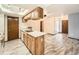 Bright kitchen with wooden cabinets, light countertops and wood-look tile flooring at 9477 W 89Th Cir, Broomfield, CO 80021