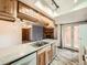 Bright kitchen with wooden cabinets, light countertops and wood-look tile flooring at 9477 W 89Th Cir, Broomfield, CO 80021