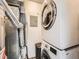 A laundry room features stacked washer and dryer units, utility connections, and neutral walls at 9477 W 89Th Cir, Broomfield, CO 80021