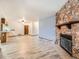 Spacious living room featuring stone fireplace and wood-look tile flooring at 9477 W 89Th Cir, Broomfield, CO 80021