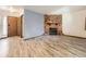 Living room featuring a stone fireplace and wood-look tile flooring at 9477 W 89Th Cir, Broomfield, CO 80021