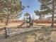 Community playground surrounded by mature trees and a well-maintained wood fence at 9477 W 89Th Cir, Broomfield, CO 80021