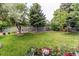 Expansive backyard featuring lush lawn, mature trees, and privacy fencing at 6120 W 111Th Ave, Westminster, CO 80020