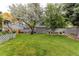 Expansive backyard featuring a large lawn, mature trees, and a storage shed at 6120 W 111Th Ave, Westminster, CO 80020