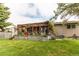 Charming backyard patio with pergola, lush landscaping, and outdoor seating area at 6120 W 111Th Ave, Westminster, CO 80020