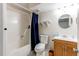 Bathroom features a shower with blue curtain, neutral walls, and single sink vanity at 6120 W 111Th Ave, Westminster, CO 80020