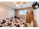 Comfortable bedroom featuring a ceiling fan, mounted TV, and natural light, designed for relaxation at 6120 W 111Th Ave, Westminster, CO 80020