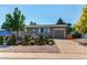 Inviting single-story home featuring a well-manicured lawn with mature trees and retaining wall at 6120 W 111Th Ave, Westminster, CO 80020