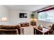 Cozy living room with comfortable seating, a mounted TV, and ample natural light at 6120 W 111Th Ave, Westminster, CO 80020