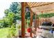 Charming covered patio with a lattice shade cover, mature trees, and space for outdoor dining at 6120 W 111Th Ave, Westminster, CO 80020