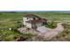 Aerial view of a home with a circular driveway and a sprawling green landscape at 28340 Dylon Cir, Elizabeth, CO 80107