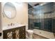Modern bathroom featuring a glass-enclosed shower with sleek blue tiles and a stylish vanity with ample storage at 28340 Dylon Cir, Elizabeth, CO 80107