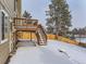 Wooden deck and stairs in a snow-covered backyard at 1218 Ascot Ave, Highlands Ranch, CO 80126