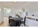 Modern dining area with a round table and chairs near entryway and kitchen at 1218 Ascot Ave, Highlands Ranch, CO 80126