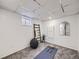 Basement exercise room with yoga mat and weights at 1218 Ascot Ave, Highlands Ranch, CO 80126