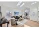 Spacious living room with hardwood floors, skylights, and ample natural light at 1218 Ascot Ave, Highlands Ranch, CO 80126