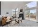 Spacious living room featuring a fireplace and sliding glass doors leading to a deck with a view at 1218 Ascot Ave, Highlands Ranch, CO 80126