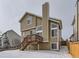 Two-story home with a deck and snow-covered backyard at 1218 Ascot Ave, Highlands Ranch, CO 80126