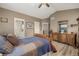 Bedroom boasting high ceilings, ceiling fan, wood floors, and an adjacent bathroom at 13263 Niwot Trl, Broomfield, CO 80020