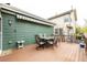 Enjoy outdoor dining on the lovely wooden deck featuring a dining table, seating, and a retractable awning for shade at 13263 Niwot Trl, Broomfield, CO 80020