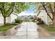 View of the home exterior framed by mature trees and lush landscaping with a long driveway at 13263 Niwot Trl, Broomfield, CO 80020