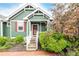 Close-up of the home's exterior, showcasing the covered porch with white railing and green siding at 13263 Niwot Trl, Broomfield, CO 80020