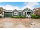 Charming green home with red shutters, a well-maintained lawn and an attached two-car garage at 13263 Niwot Trl, Broomfield, CO 80020