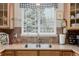 Kitchen view highlighting the sink, cabinets, and natural light at 13263 Niwot Trl, Broomfield, CO 80020