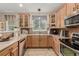 Bright kitchen features stainless steel appliances, ample cabinets, and tile backsplash at 13263 Niwot Trl, Broomfield, CO 80020