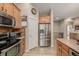 Modern kitchen with stainless steel refrigerator and wood cabinets at 13263 Niwot Trl, Broomfield, CO 80020