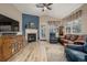 Inviting living room with blue accent wall, a fireplace, neutral flooring, and comfortable seating at 13263 Niwot Trl, Broomfield, CO 80020