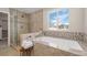 Spa-like bathroom featuring a soaking tub and walk-in shower at 6858 Johnson St, Arvada, CO 80004