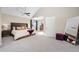 Spacious primary bedroom with plush carpet and large windows at 6858 Johnson St, Arvada, CO 80004